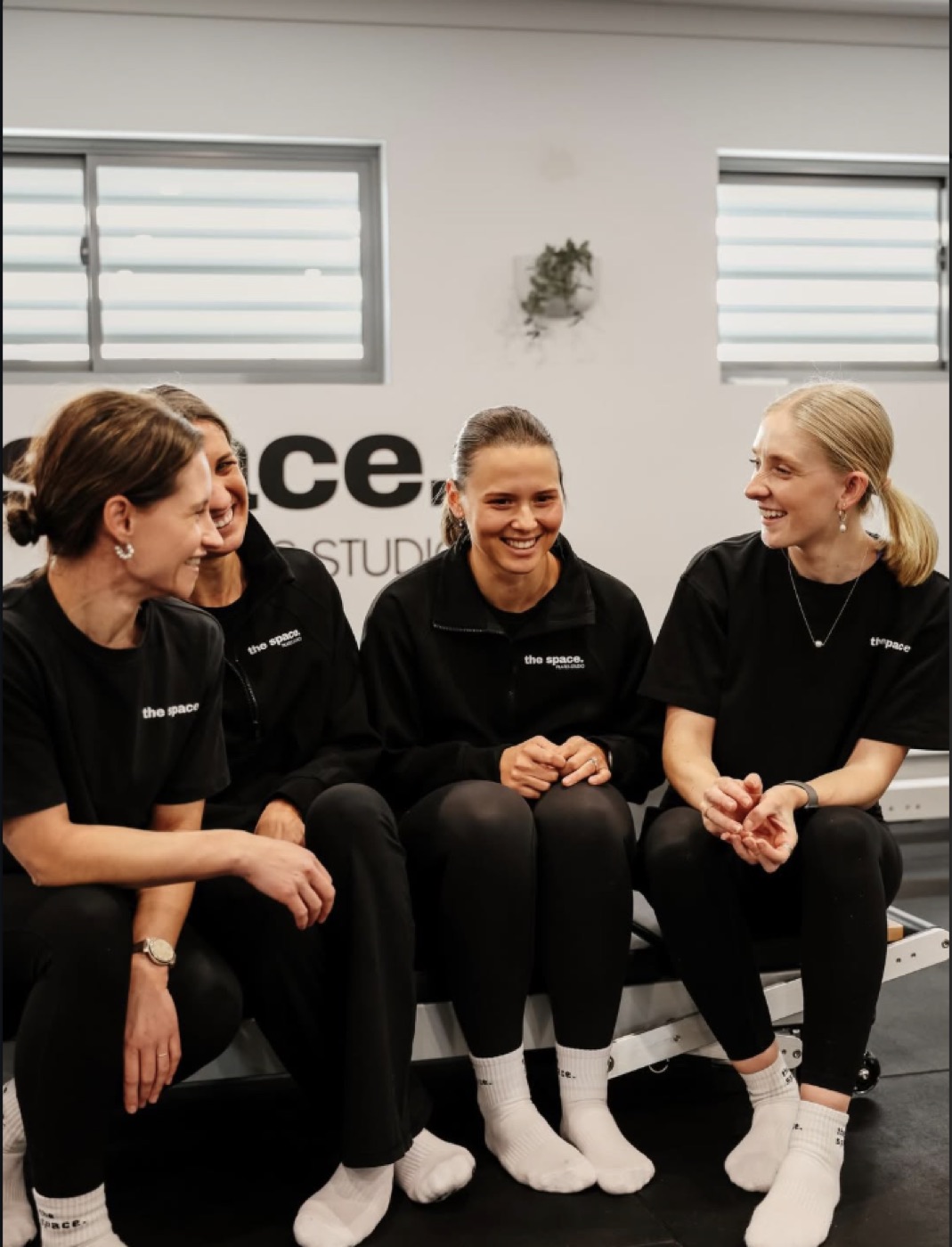 The Space members laughing together on a reformer